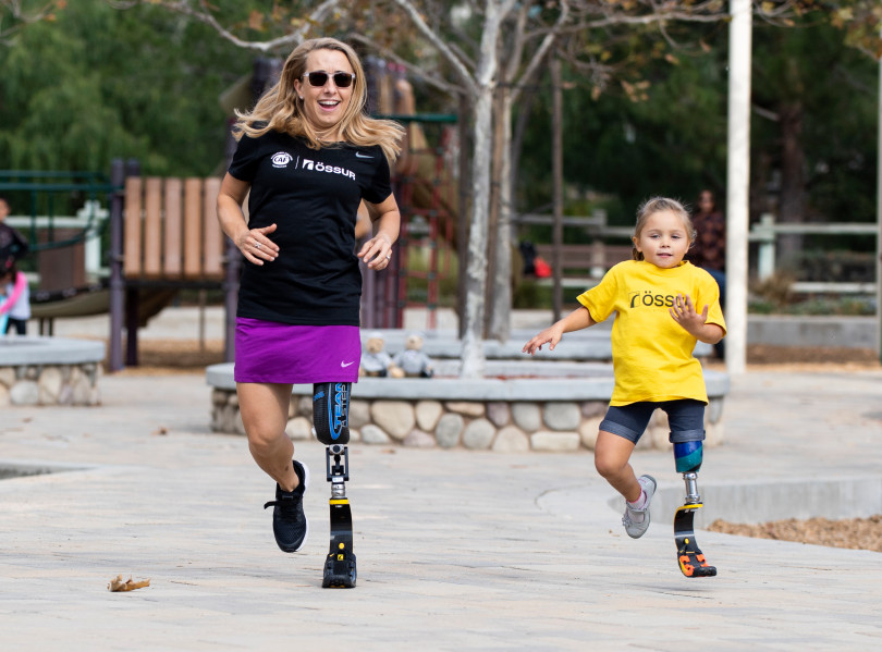 Sarah Reinertsen runs mentors Morgan Pixley, age 5